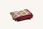 Pink floral hand block print sherpa throw blanket with crimson velvet ruffle.