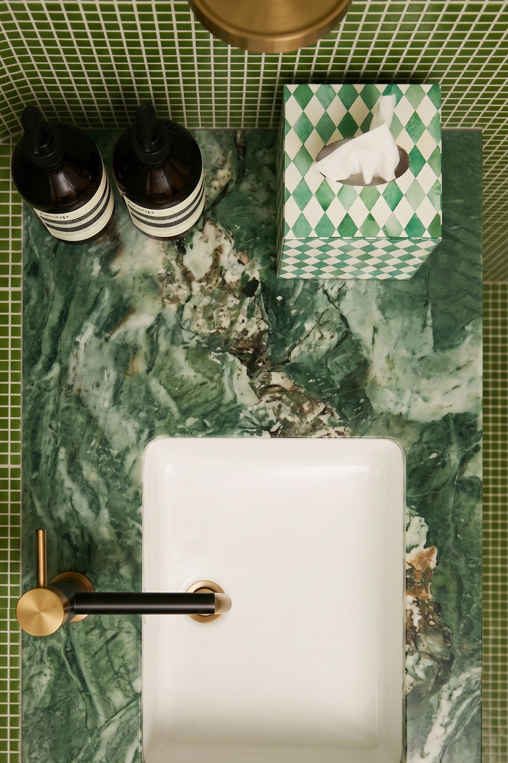 Green and white bone inlay tissue box styled in a bathroom with a hand towel.