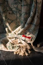 Teal hand block print European flax linen throw draped over a chair.