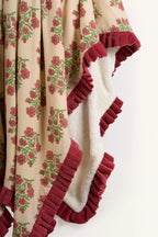Pink floral hand block print sherpa throw blanket showing the crimson velvet ruffle.