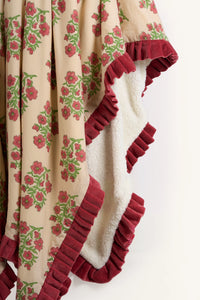 Pink floral hand block print sherpa throw blanket showing the crimson velvet ruffle.