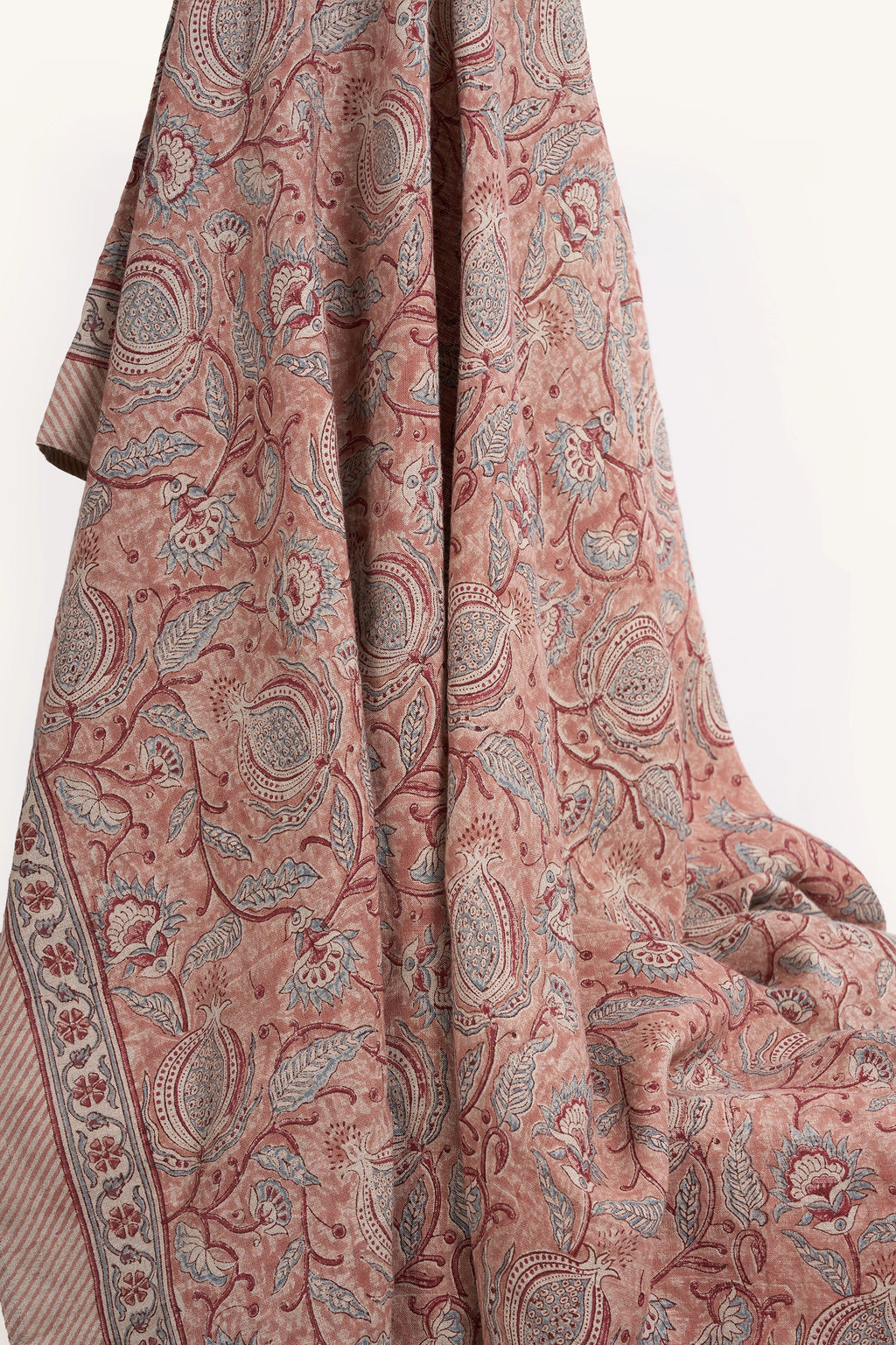 Pink floral hand block print European flax linen tablecloth draped to showcase the botanical pattern.