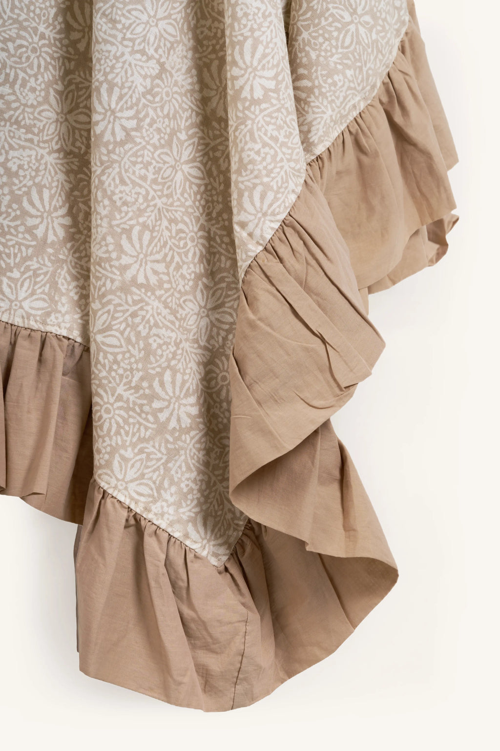 Close-up of Ruffled Botanics European linen tablecloth showing the cotton cambric ruffle and hand block printed floral motif.