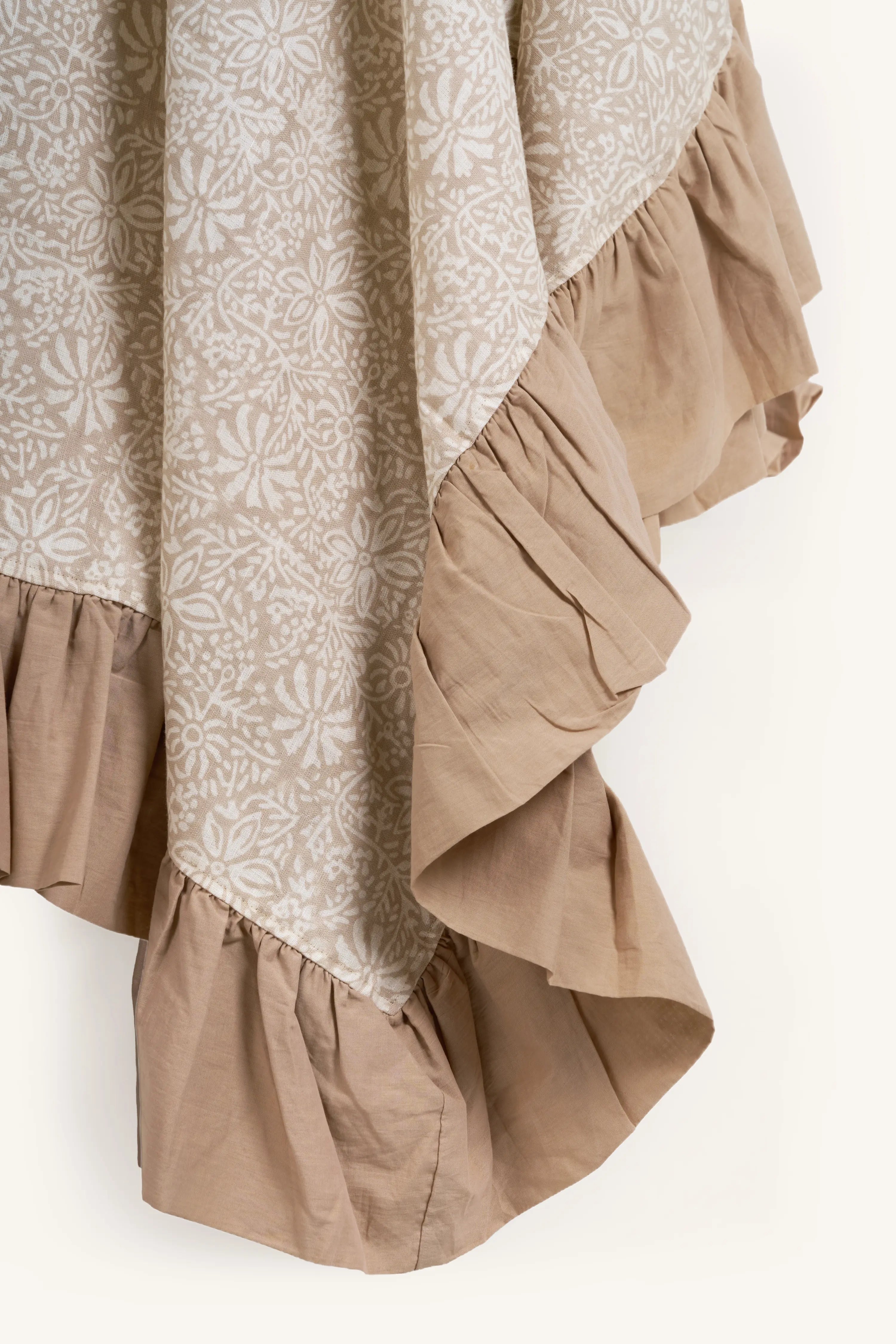 Close up of the ruffled edge on the beige hand block print European flax linen tablecloth.