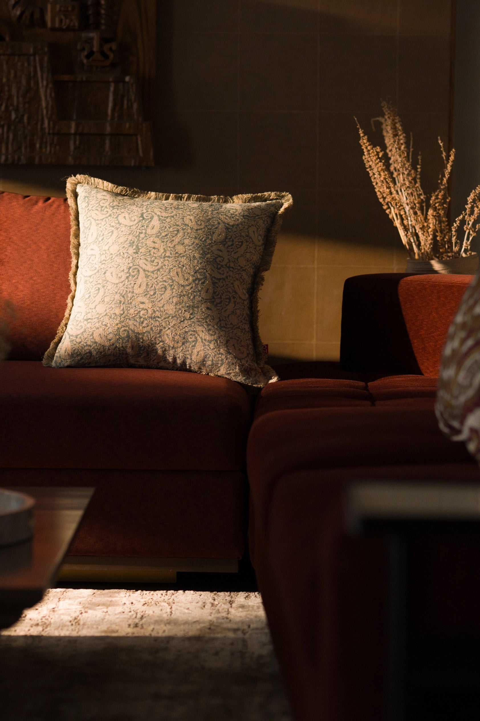 Hand block print European flax linen cushion styled in a living room.