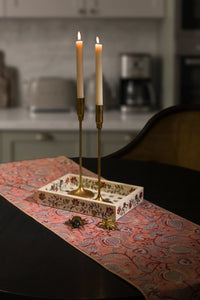 Pink hand block print cotton dining table runner styled on an elegant dining table.