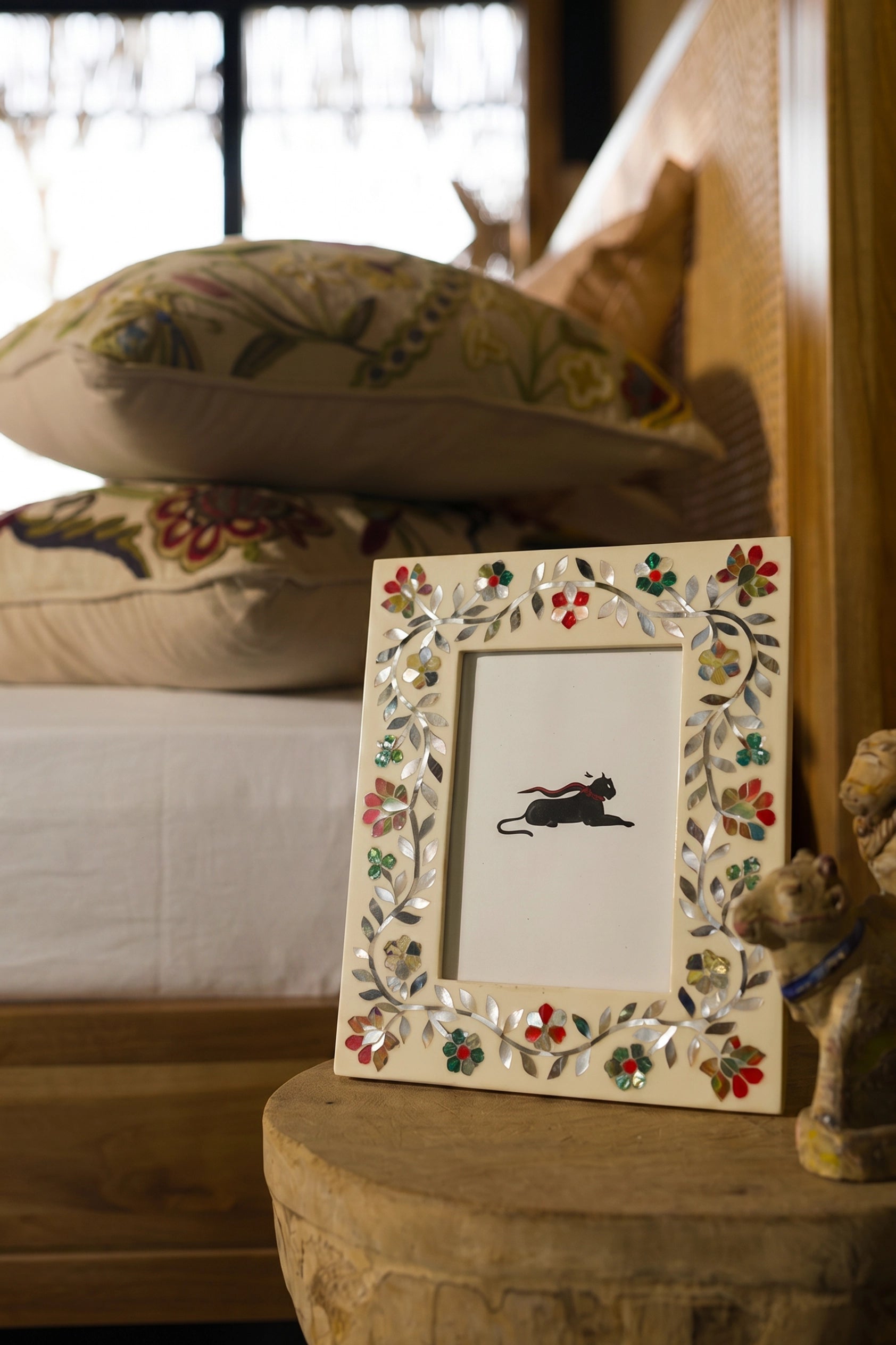 Mother of Pearl inlay photo frame styled on a bedside table.