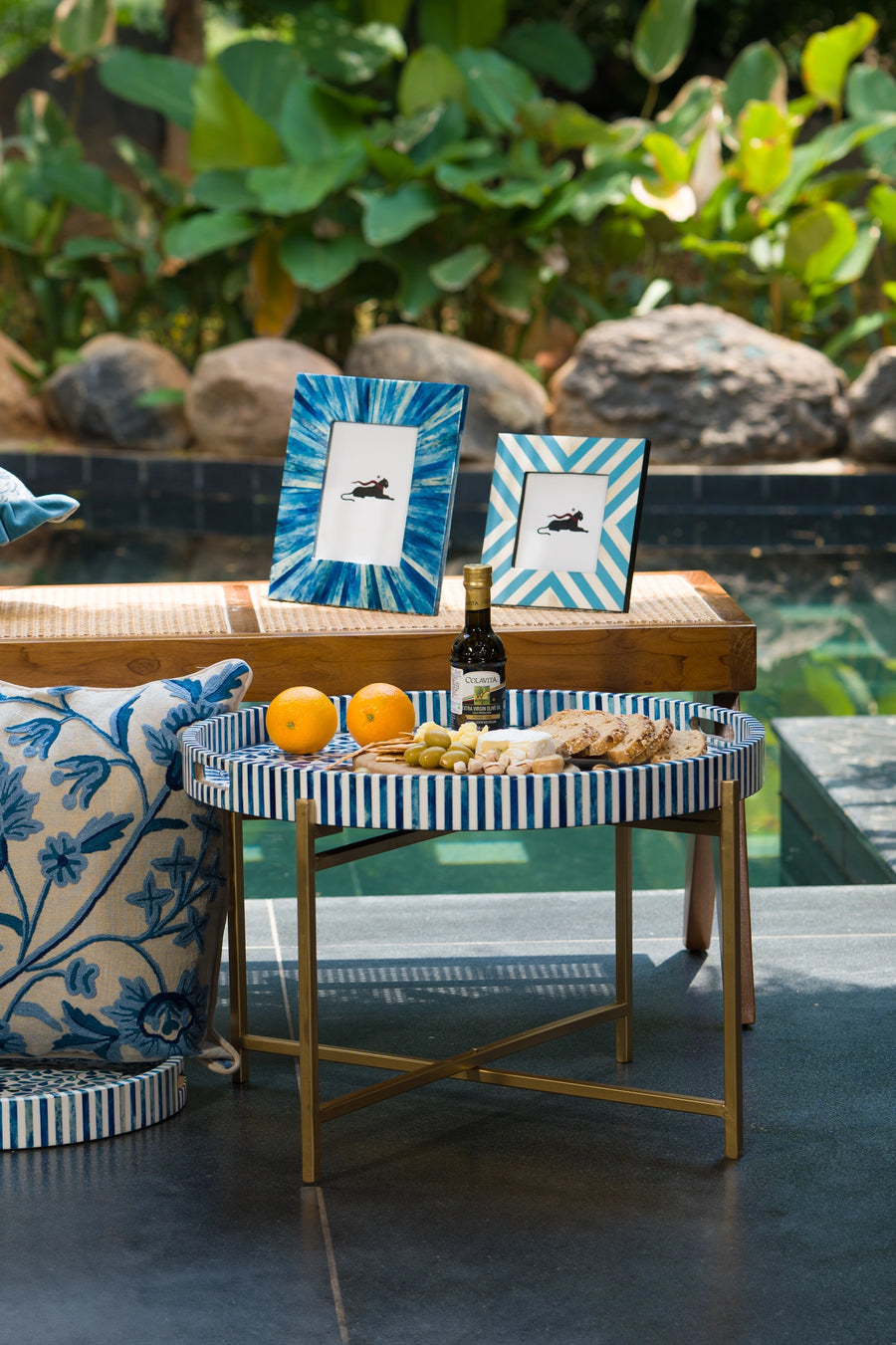 Blue and white chevron bone inlay photo frames styled outdoors on a side table.