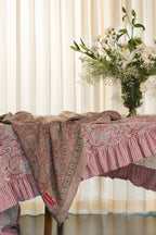 Pink floral hand block print European flax linen tablecloth styled on a dining table with floral arrangement.