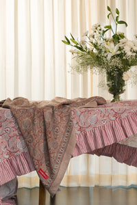 Pink floral hand block print European flax linen tablecloth styled on a dining table with floral arrangement.
