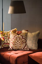 Hand block print European flax linen cushion styled with other decorative cushions on a sofa.