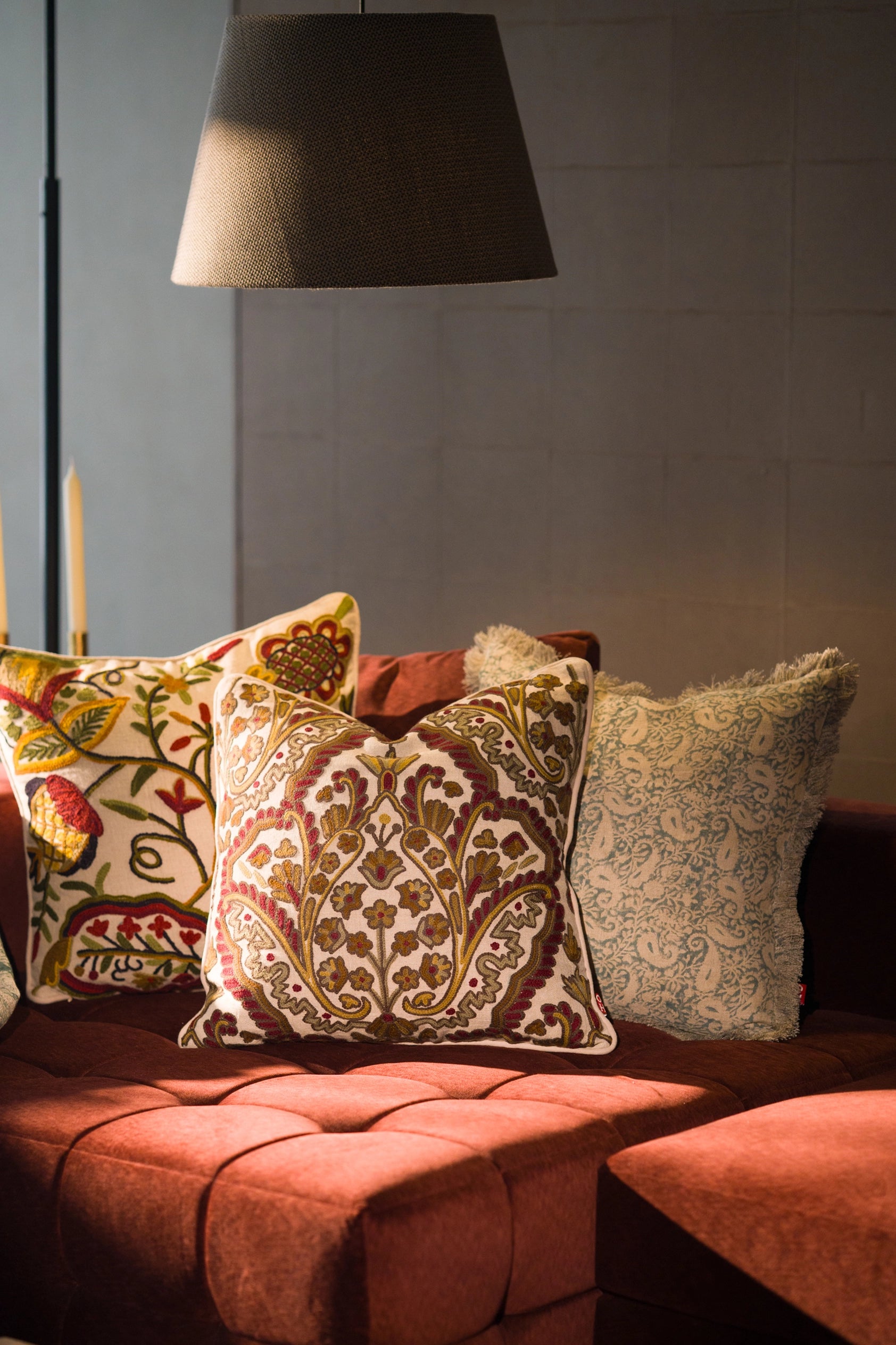 Hand block print European flax linen cushion styled with other decorative cushions on a sofa.