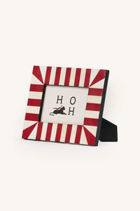 Square red and ivory starburst bone inlay photo frame displayed upright.