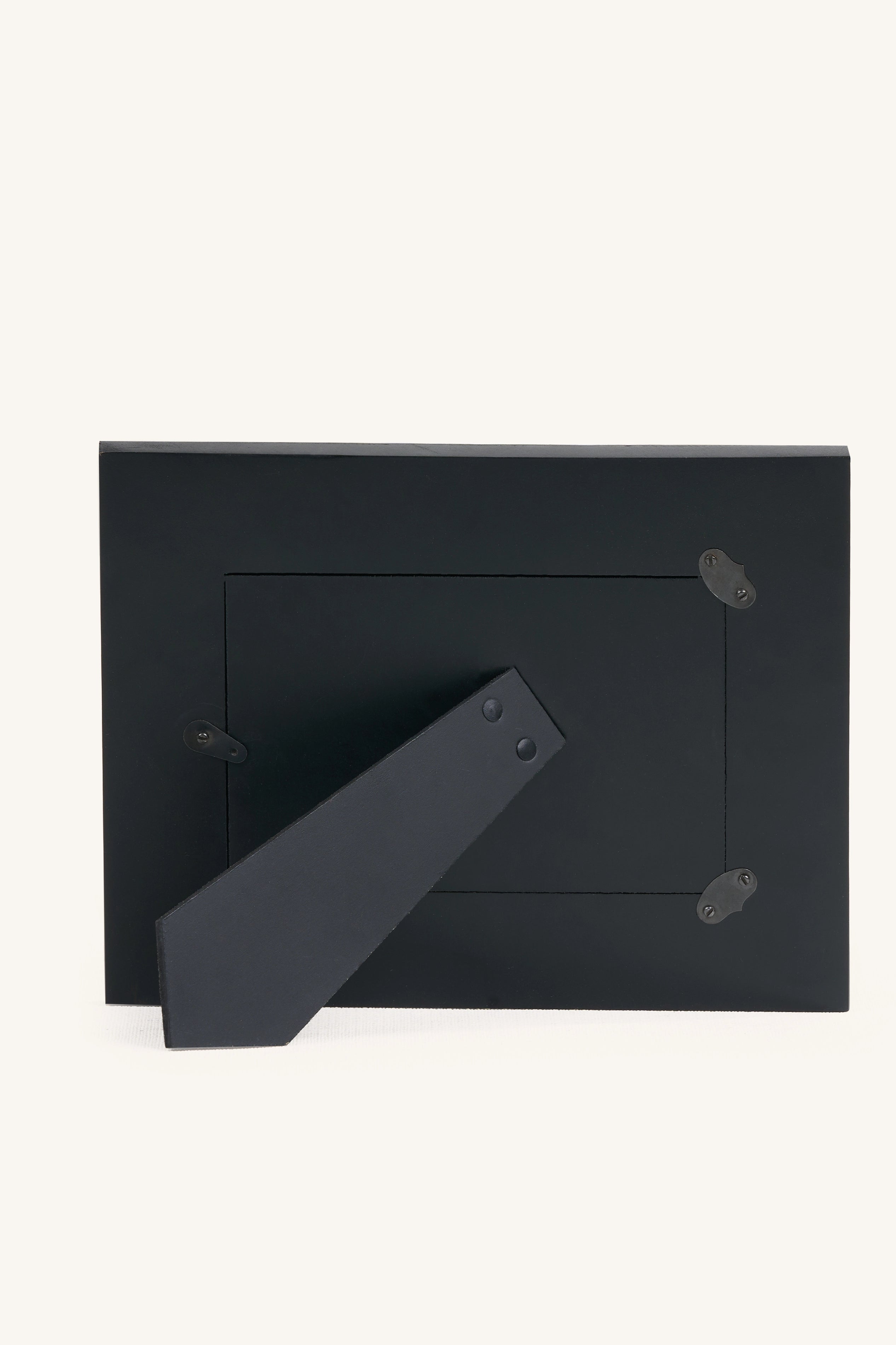 Rear view of the square red and ivory bone inlay photo frame with black stand.