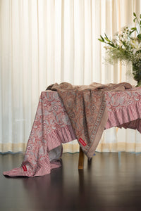 Pink floral hand block print cotton tablecloth styled on a dining table with floral arrangement.