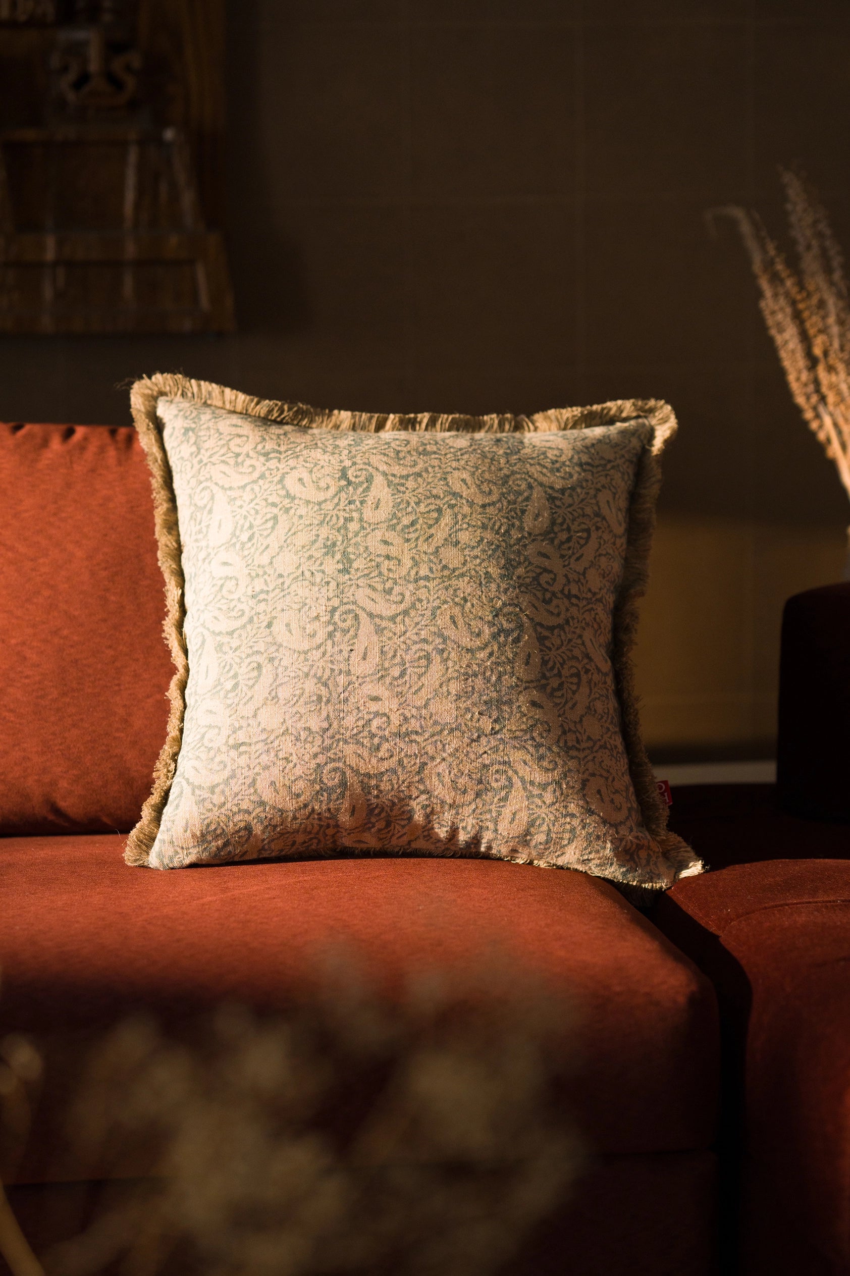 Hand block print European flax linen cushion styled on a sofa.