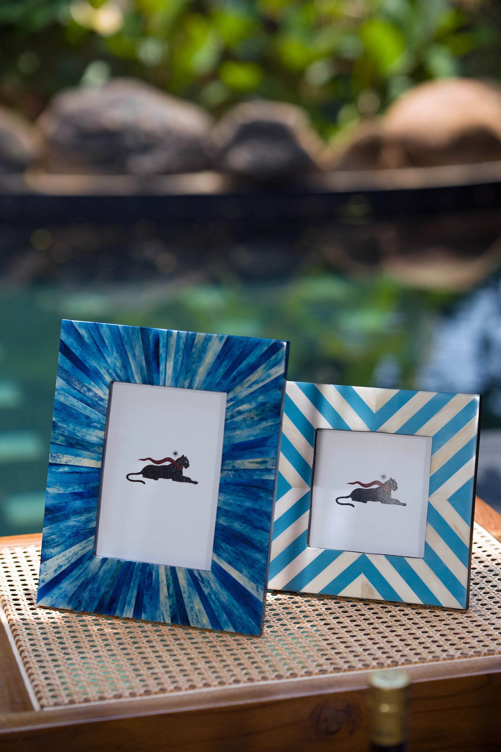 Blue bone inlay photo frame styled on a console with decorative accessories.