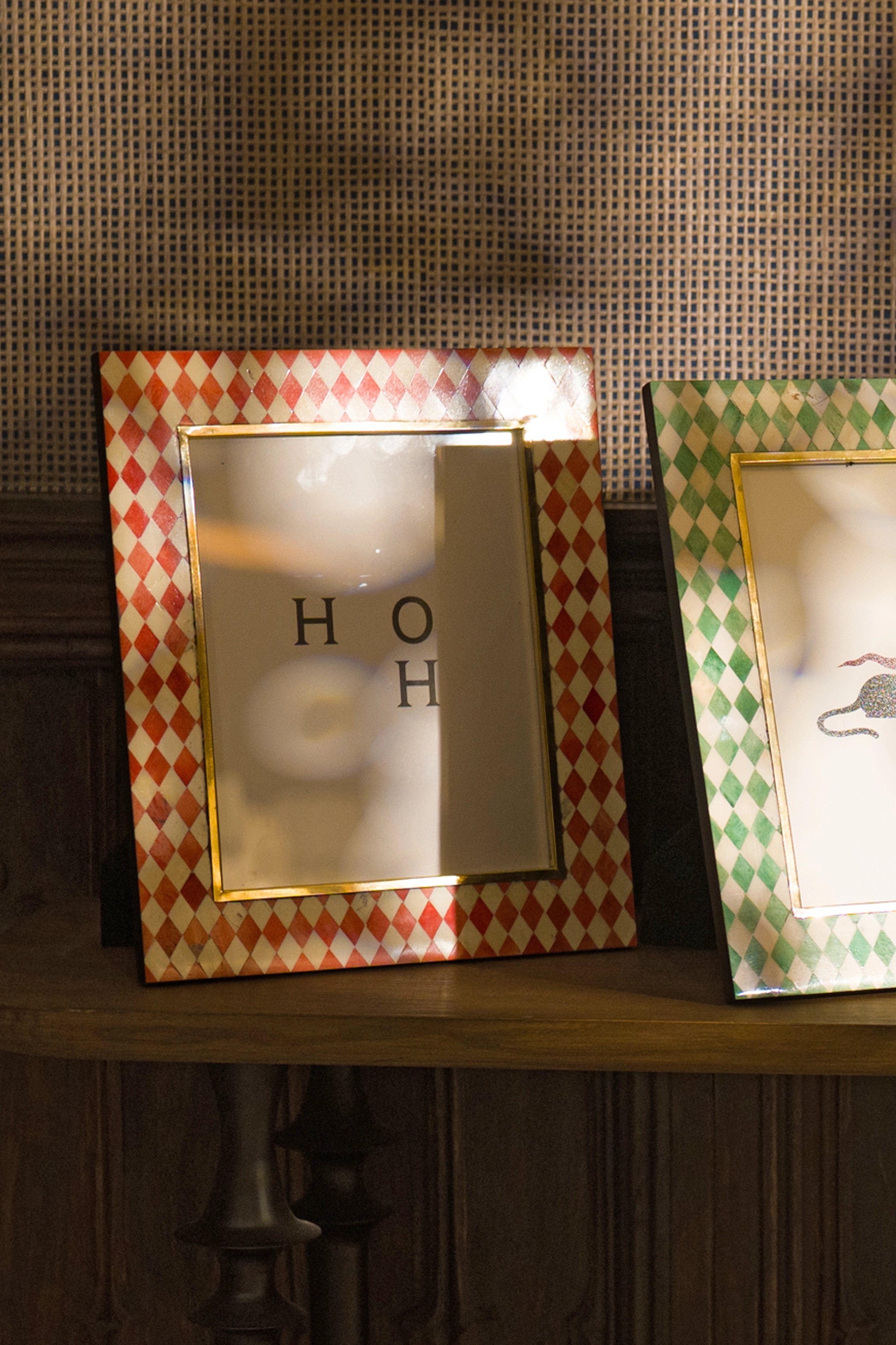 Rectangular red and ivory harlequin bone inlay photo frame displayed on a shelf.