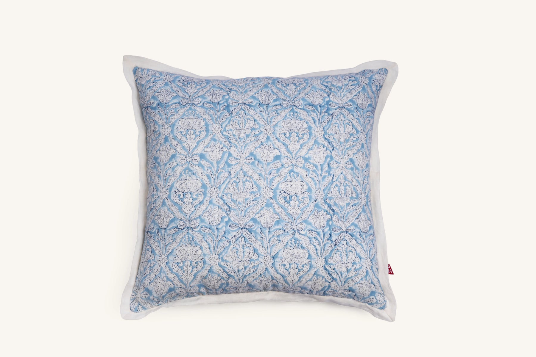 Sky blue hand block print European flax linen cushion with white flange edge.