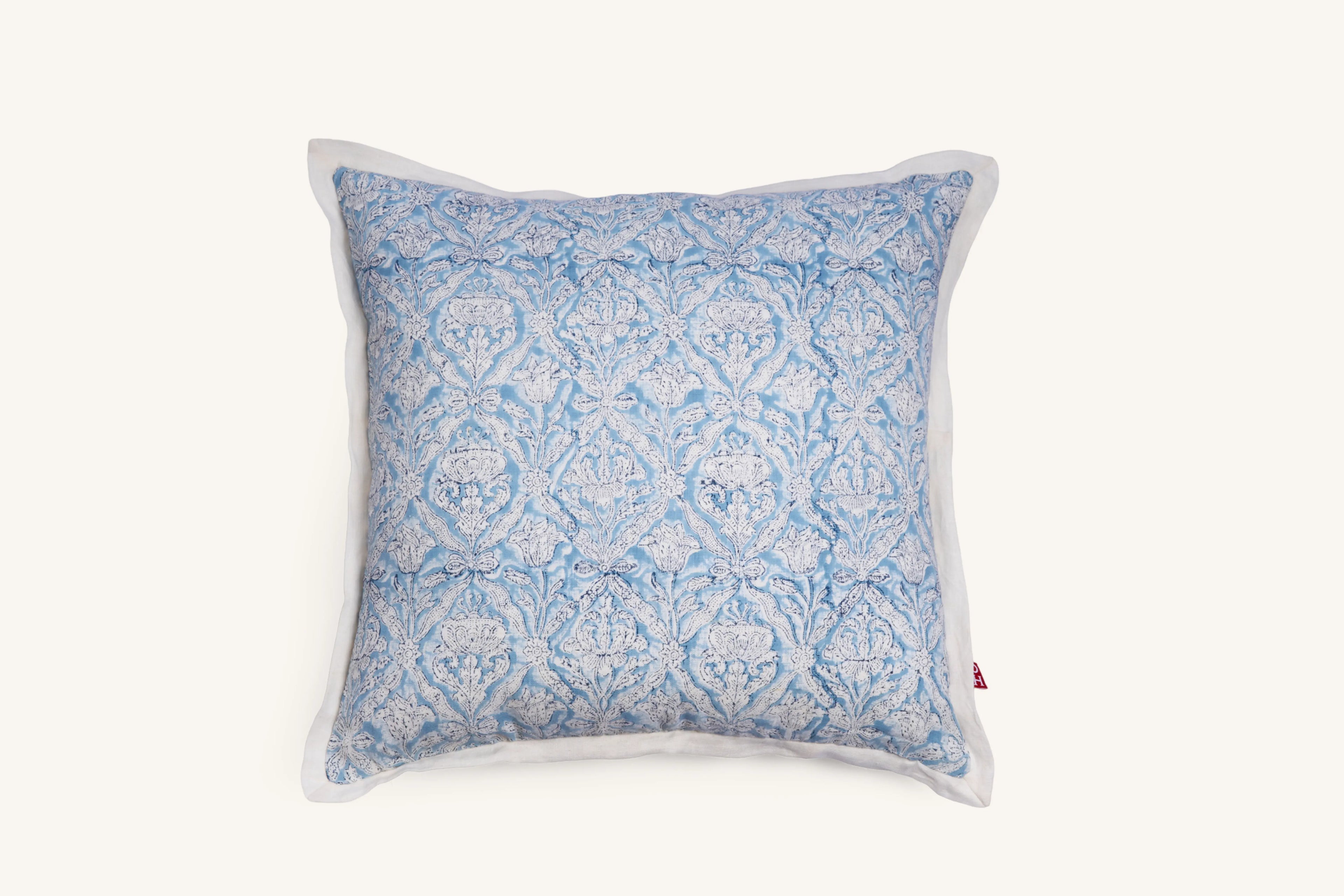 Sky blue hand block print European flax linen cushion with white flange edge.