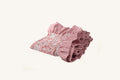 Pink floral hand block print cotton tablecloth with pleated striped ruffle.