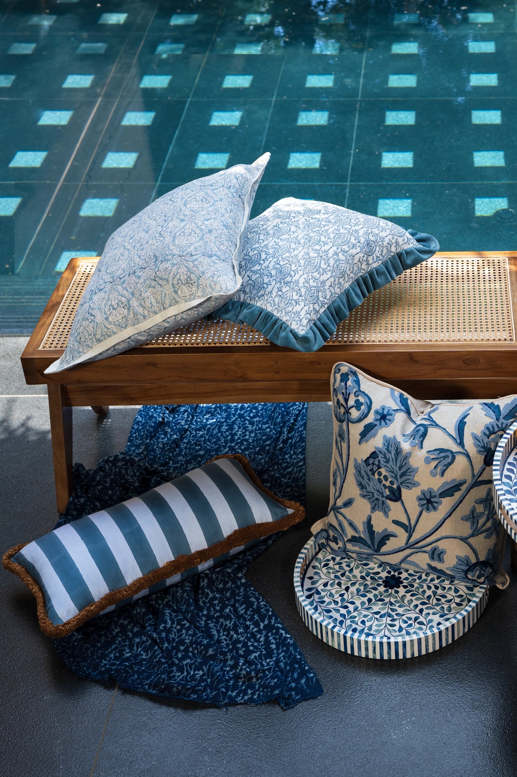 Sky blue hand block print European flax linen cushion styled with coordinating cushions on outdoor seating