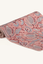 Pink hand block print cotton dining table runner showing floral pattern.