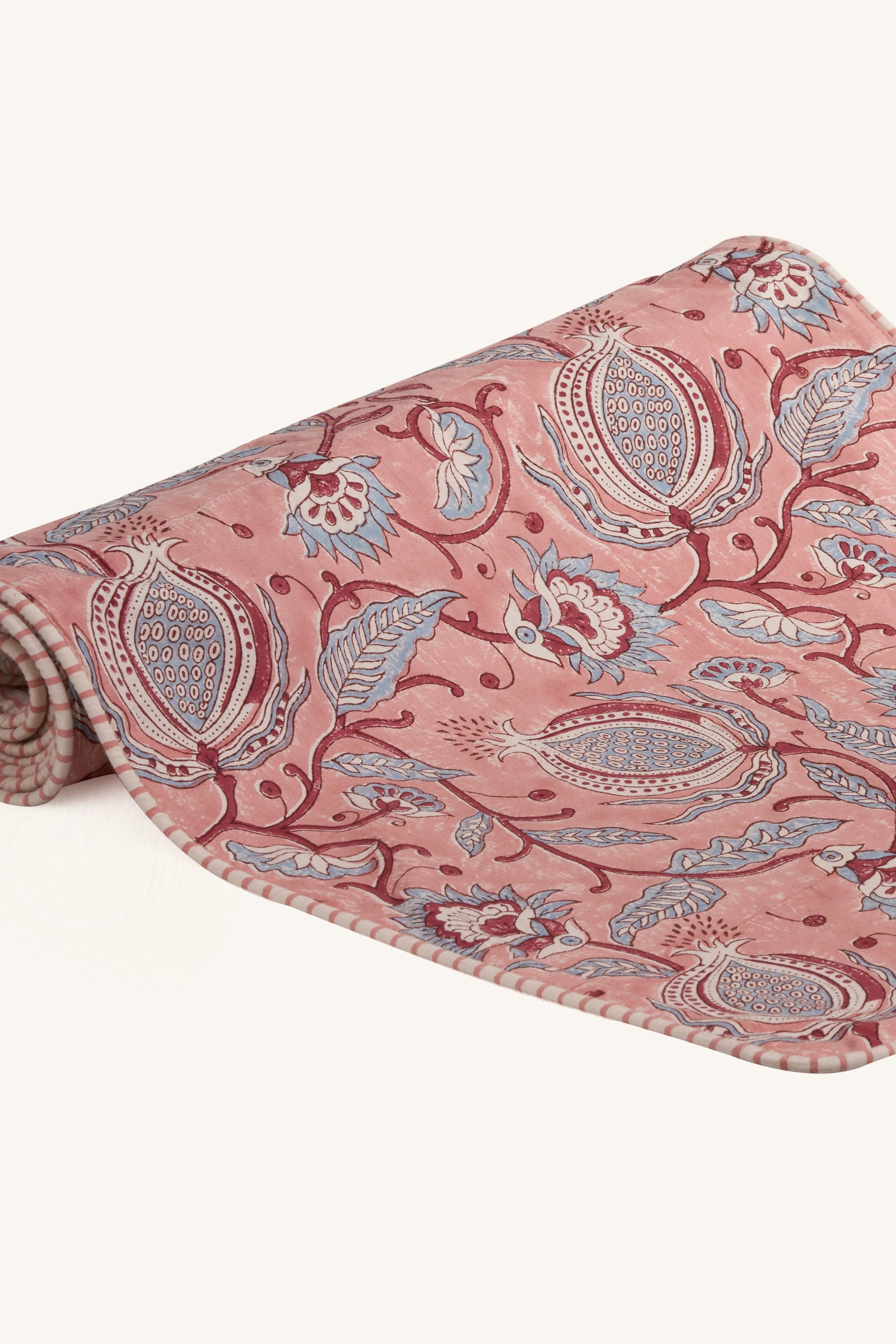 Pink hand block print cotton dining table runner showing floral pattern.