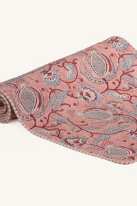 Pink hand block print cotton dining table runner showing floral pattern.