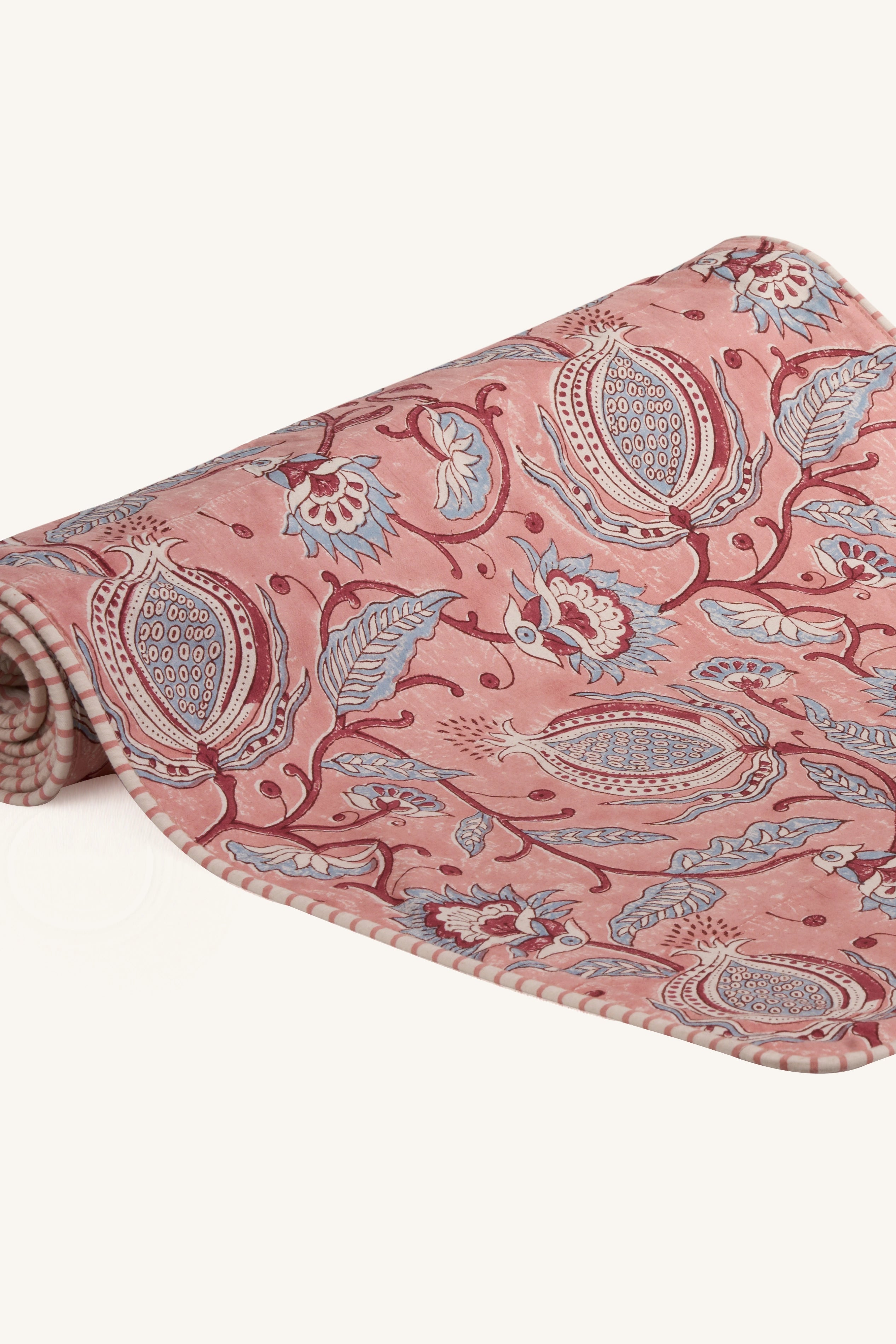 Pink hand block print cotton dining table runner showing floral pattern.